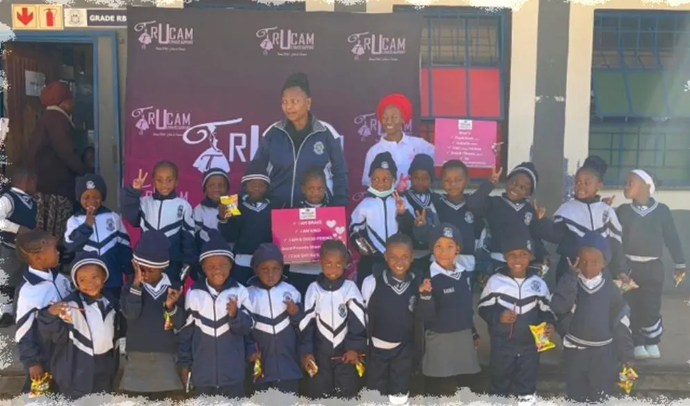 Young learners in school uniform with the TruCam team at a school in Limpopo